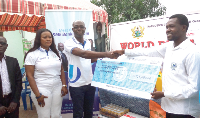 Mr Kwasi Nimako (2nd left) presenting a dummy cheque to the Director of DAFAREC, Mr Emmanuel Agyapong (right). With them is Mrs Victoria Esinam Assah Offei of NACOB Mr Kwasi Nimako (2nd left) presenting a dummy cheque to the Director of DAFAREC, Mr Emmanuel Agyapong (right). With them is Mrs Victoria Esinam Assah Offei of NACOB