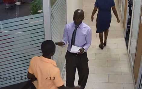 File photo: This man was caught on a CCTV camera sometime in March when he posed as a worker of a bank and allegedly swindled the boy who had been sent to make a deposit. File photo: This man was caught on a CCTV camera sometime in March when he posed as a worker of a bank and allegedly swindled the boy who had been sent to make a deposit.