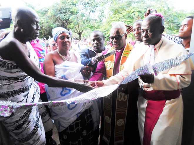 Former Presiding Bishop of the Methodist Church of Ghana, Most Rev Dr Robert Aboagye-Mensah, (second right), Bishop of the Sunyani Diocese of the Methodist Church, Rt Rev Kofi Asare-Bediako (right) and Nana Kwasi Yeboah (left), Chief of Asuakwaa, jointly cutting the tape for the inauguration of the clinic with Mr Baffuor-Awuah at the background holding the microphone. Sunyani West MP, Methodist Church provides clinic for Asuakwaa