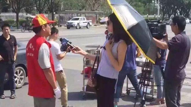 Did the journalist damage her profession with her umbrella and sunglasses Did the journalist damage her profession with her umbrella and sunglasses
