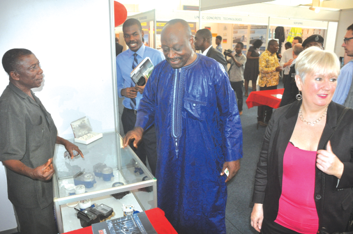 Dr Kwaku Agyemang-Mensah (2nd right), at one of the stands at the exhibition in Accra. Picture: SAMUEL TEI ADANO Stalled housing programme revamped