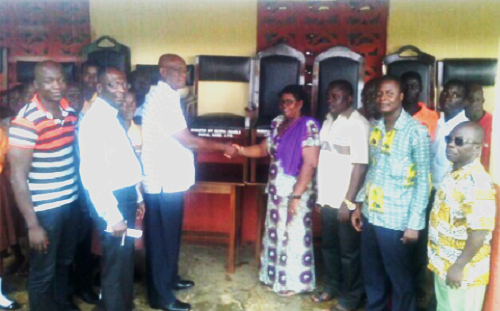 The Board Chairman of the bank, Mr Emmanuel Yankson (3rd left), presenting the furniture to Mrs Akoako, while some management members of the bank and staff of the school and the education directorate look on. Turn attention to deterioration of structures — School authorities