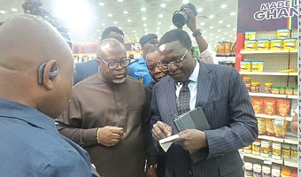 Dr Martin Kolbil Yamborigya (right) of the Domestic Tax Division of the Ghana Revenue Authority (GRA) assessing an invoice to verify its reconfiguration in line with the new VAT reforms. With him are Anthony Kwasi Sarpong (middle), Commissioner-General of the GRA, and other officials during a working visit