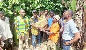 Dr Francis Baah (3rd from left), Deputy CEO of COCOBOD, presenting some cocoa products to Mohammed Yinchala during the visit