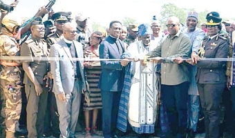 An Administrative Block of the Prison Camp in Damongo. INSET: President John Mahama (3rd from right) being suported by Patience Baffoe-Bonnie (right),  Director-General, Ghana Prison Service; Apostle Dr Eric Kwabena Nyemekye (5th from right), Chairman, Church of Pentecost, and other dignitaries and traditional rulers to inaugurate the camp