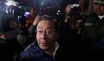 Police officers escort former President Luis Arce to San Pedro Prison after his arrest as part of a corruption investigation in La Paz, Bolivia, on December 12, 2025. | Photo Credit: AP