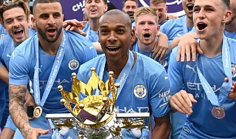 Fernandinho (with trophy) celebrates winning the 2021/22 Premier League, his fifth league title