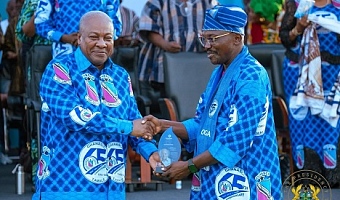 President Mahama receiving a gift from Douglas Yakubu, Headmaster of GHANASCO