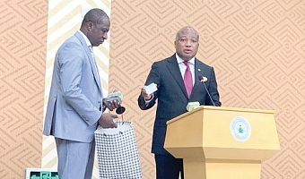 Samuel Okudzeto Ablakwa (right), Minister of Foreign Affairs, displaying one of the confiscated Ghana Cards. With him is Yahaya Amantana Mahama (left), Director, Passport