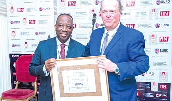 Alex Apau Dadey (left), Executive Chairman of KGL Group, receiving a citation from Mark A. Furlong of Forbes