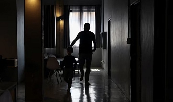 A Palestinian man, one of 130 granted entry to South Africa after initially being denied for not meeting immigration requirements, walks with his child after speaking to Reuters at an undisclosed location in Johannesburg, South Africa, November 14, 2025. REUTERS/Siphiwe Sibeko