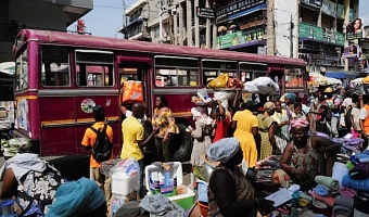 Traders sell goods along a busy street at Makola market in Accra, Ghana, December 6, 2025. REUTERS/Francis Kokoroko