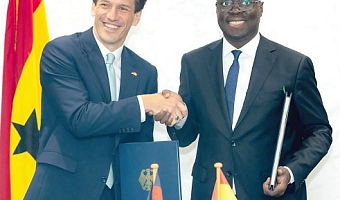 Dr Cassiel Ato Forson (right), Minister of Finance, and Frederik Landshöft, German Ambassador to Ghana, in a handshake after the signing ceremony