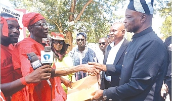 Alhaji Saibu Braimah (left),  Chairman of Association of Ghana Rice Producers and Processors, presenting a petition to Ali Adolf John (right), Northern Regional Minister, after the protest