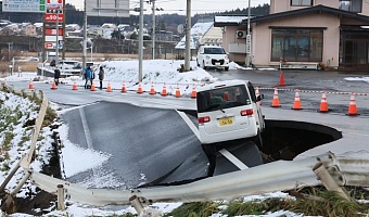 A car is stranded on a collapsed road in Tohoku, Northern Japan