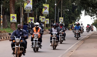 Motorcycle taxis ride past campaign posters of Uganda's President and leader of the ruling National Resistance Movement (NRM) party, Yoweri Museveni, ahead of the upcoming general election in Kampala, Uganda October 13, 2025. REUTERS/Miriam Watsemba/File Photo