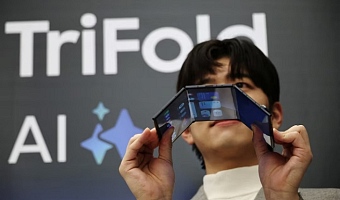 A model poses for photographs with a Galaxy Z TriFold during an event at its store in Seoul, South Korea, December 2, 2025. REUTERS/Kim Hong-Ji