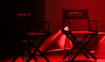 Two director's chairs with the Netflix logo sit on a stage at a convention in Lucca, Italy, October 31, 2025. REUTERS/Claudia Greco