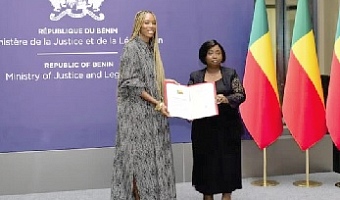  Isaline Attely, an Afro-descendant from Martinique, receiving her certificate of Beninese nationality during a naturalisation ceremony in Cotonou, Benin 