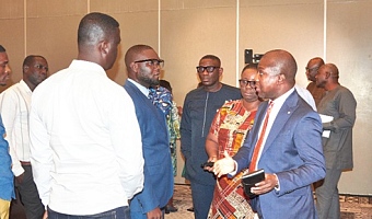 Kwesi Afreh Biney (right), Director-General, SSNIT, with Evelyn Adjei (2nd from right), Chief Actuary, SSNIT, explaining a point to some journalists after the event