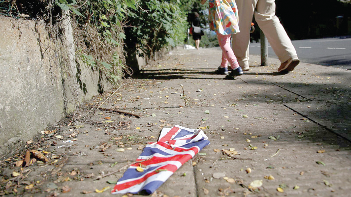 A British flag which was washed away by heavy rains the day before lies on the street in London A British flag which was washed away by heavy rains the day before lies on the street in London