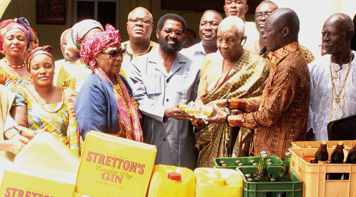 Oblempong Nii Kojo Ababio V (4th right) receiving the items from Mr Alfred Okoe Vanderpuije (4th left) and Nii Lantey Vanderpuye (3rd right), the Minster of Youth and Sports Govt presents items towards Homowo festival