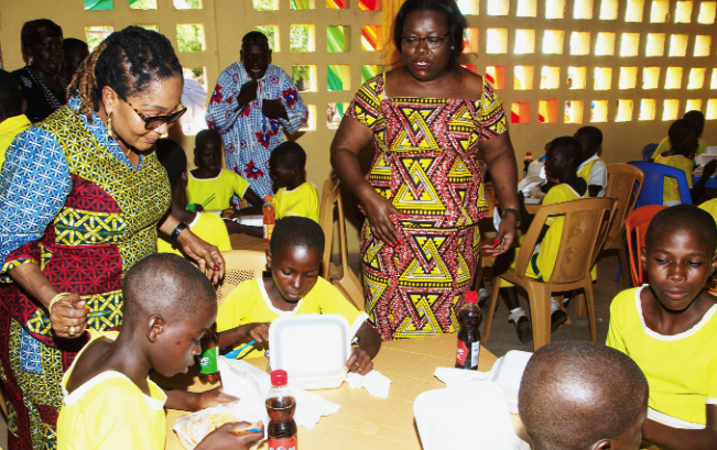 Mrs Lordina Mahama and Nana Oye Lithur, the Minister of Women, Gender and Social Protection, interacting with the children in the dining hall First Lady inaugurates dining hall, kitchen for Jakpa RC Primary School