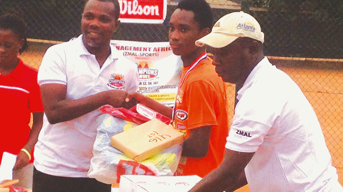 David Derhnick Coffie (left) presenting an award to U-16 boys winner Roland Torttimah David Derhnick Coffie (left) presenting an award to U-16 boys winner Roland Torttimah