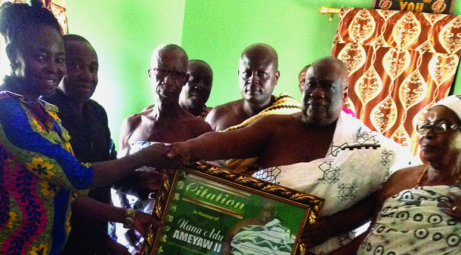 Mrs Jennifer Appiah-Bempah ( left) presenting a citation to Nana Adu Ameyaw, Effiduasihene (2nd right). looking on are Nana Konadu Yiadom, Queenmother of Effiduasi (right), and Nana Otuo Acheampong, the Sekyere-East District Director of Education (2nd left) Chief gives land for hostel construction for national service persons