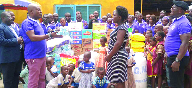 The Chairman of the Association, Nana Agyeman Opambour, presenting the items to the Caretaker of the Royal Seed Home, Madam Hannah Krampah Kantamanto United Association supports orphanage