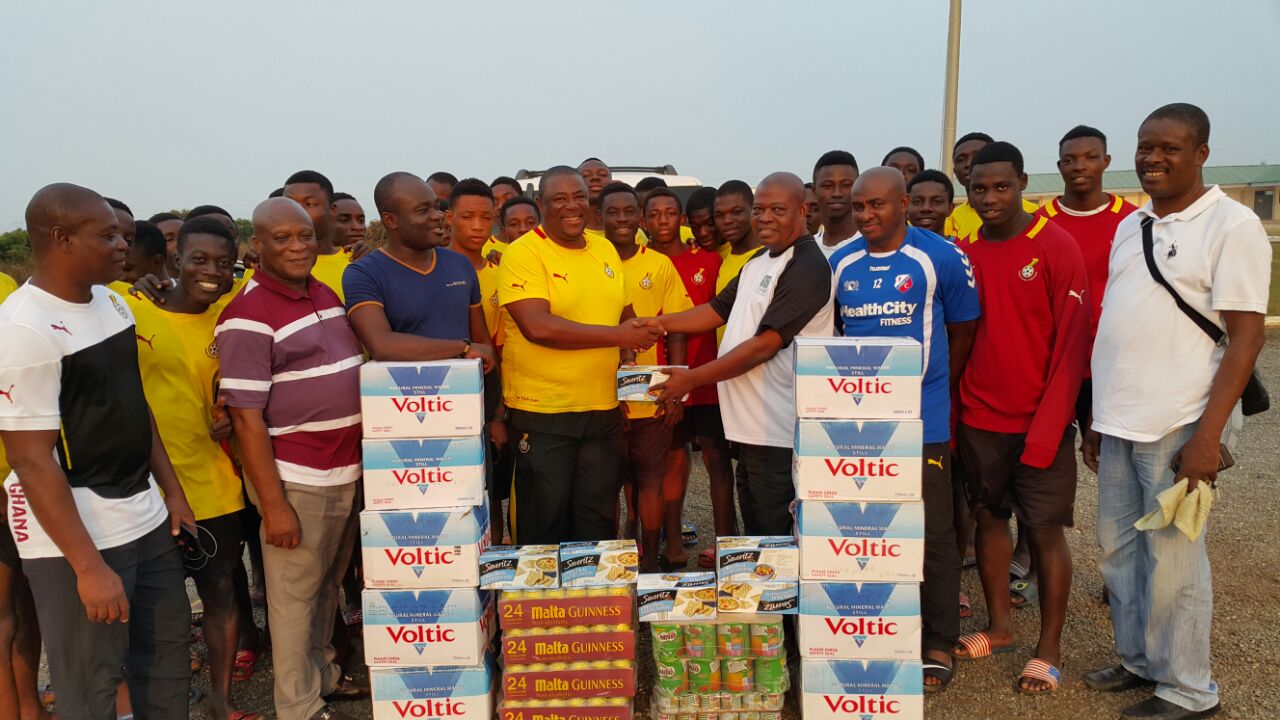 Coach Fabin receiving the items from Mr Blagogee Coach Fabin receiving the items from Mr Blagogee