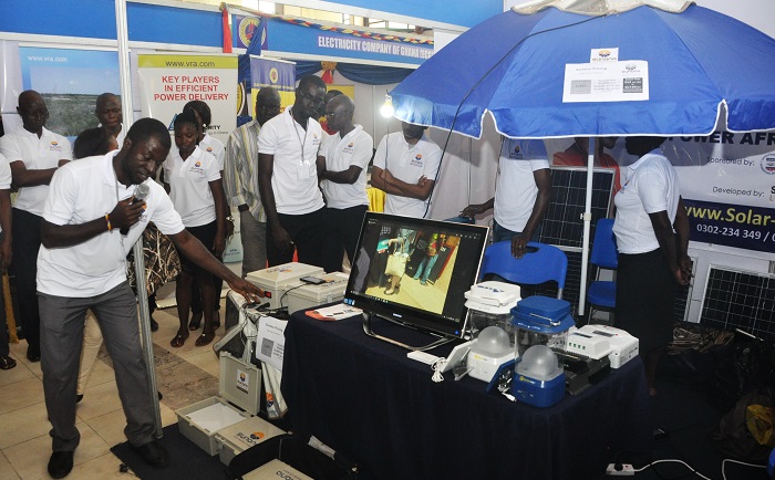 Mr Kwame Ampong (left), the Technical Officer, Solar Light Company Limited, explaining how the system works. Picture: SAMUEL TEI ADANO