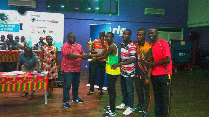 Alhaji Musah Ibrahim (left) of the National Sport Authority presenting the cash prize to the Immigration men's team for winning the league. Alhaji Musah Ibrahim (left) of the National Sport Authority presenting the cash prize to the Immigration men's team for winning the league.