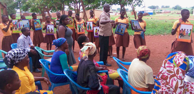 The Regional Director of the NCCE, Mr Pontius Pilate Apaaby Baba (hand stretched), facilitating a discussion at Sheaga using toolkits NCCE collaborates with UNICEF to eradicate child marriage in Talensi