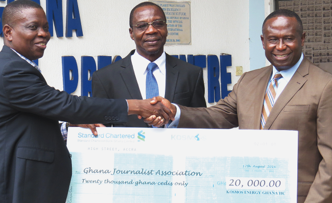 Mr Dave Agbenu, General Secretary of the GJA, thanking Mr Joe Mensah of Kosmos for the donation. With them is Mr Affail Monney, GJA President Kosmos supports 21st GJA Awards