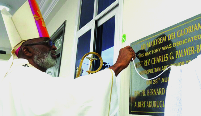Most Rev. Palmer-Buckle unveiling a plaque to officially open the mission house for the St Patrick Catholic Church St Patrick Catholic Church elevated to parish