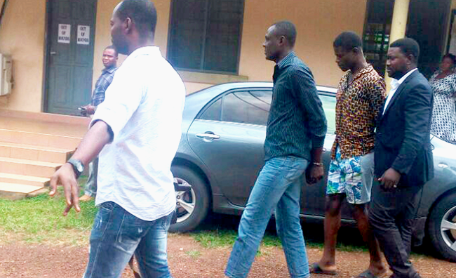 The accused being escorted out of the court 2 Cops appear in court for attacking bullion van