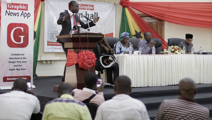 Mr Asamoah-Siaw of the PPP taking his turn to address the meeting. Sitting from right: Mr Quarmyne (NDC), Mr Annang (NPP) and Mrs Aryee (NDP)