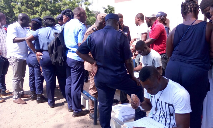 Mr Titus-Glover (left) in a chat with some security officers at Tema East Constituency. Picture: Samuel Tei Adano