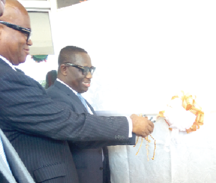 Mr Enest Thompson (right) cutting tape to unveil the new biometric terminal Mr Enest Thompson (right) cutting tape to unveil the new biometric terminal