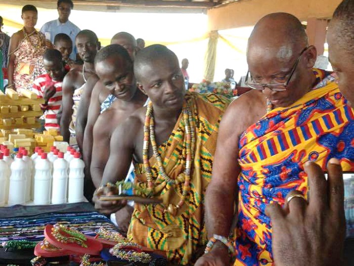 Nana Nkwantabisa (second right) and some chiefs, inspecting some of the products made by the women
