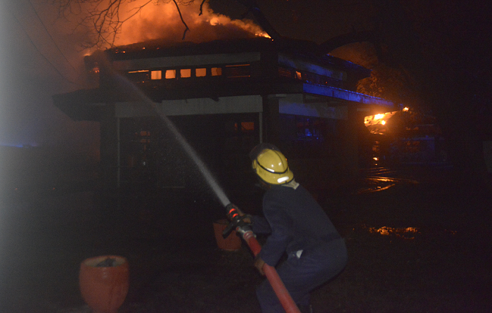  A firefighter trying to put out the fire  (main picture) and some nurses of the 37 Military Hospital attending to a victim (INSET)