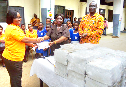 The Customer Service Manager of the Social Security and National Insurance Trust (SSNIT), (left) Mrs Victoria Abaidoo presenting some books to the acting Executive Director of the Ghana Library Board, Mrs Rebecca Akita