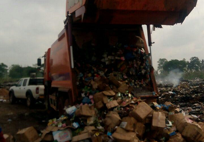 The unwholesome goods being offloaded at a refuse dump for destruction The unwholesome goods being offloaded at a refuse dump for destruction