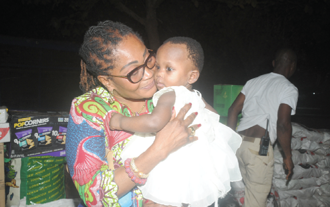 Mrs Lordina Mahama cuddling a child at the Tamale Children’s Home Mrs Lordina Mahama cuddling a child at the Tamale Children’s Home