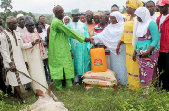 The Adawso Chief Imam, who is also the Zongo Chief, Adam Muhamed, thanking Mrs Florence Asiedu-Ofei, the wife of the parliamentary candidate, after receiving the cow and the other items. With them are some of the Muslims and ladies who accompanied Mrs Asiedu-Ofei Businessman supports Muslims to mark festival