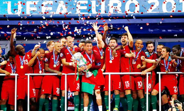 Portugal’s captain, Cristiano Ronaldo (7) lifts the Euro 2016 Cup in celebration with teammates It is Portugal at last!
