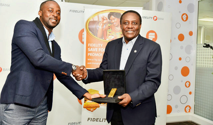 Ultimate winner Festus Armoh Nweamah (left) receiving a 1kg 24 carat gold bar from Mr Jim Baiden Ultimate winner Festus Armoh Nweamah (left) receiving a 1kg 24 carat gold bar from Mr Jim Baiden