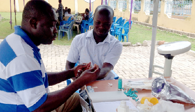 Mr Emmanuel Mahama Amin taking blood sample from a donor for screening before the donation Mr Emmanuel Mahama Amin taking blood sample from a donor for screening before the donation