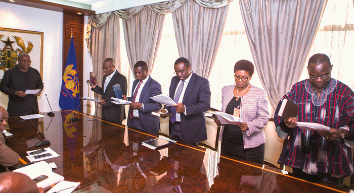  President John Mahama (left) swearing in the board members.